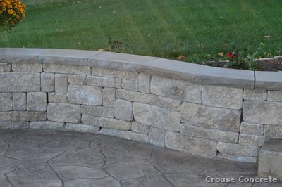 Stamped Concrete Patio with Stone Retaining Wall